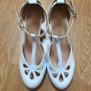 White patent leather T-strap Teardrop Cut Out pumps